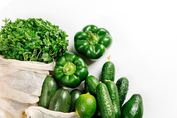 Organic vegetables and fresh green in reusable produce bags. Sustainable lifestyle. Plastic free concept. Flat lay, top view