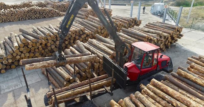 Truck with manipulator unload logs, work equipment at a woodworking factory, factory work, sawmill work