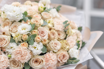 Large Beautiful bouquet of mixed flowers in woman hand. Pink and white color. the work of the florist at a flower shop. Delicate Pastel color. Fresh cut flower.