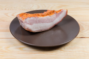 Pice of boiled smoked pork belly on dish on table