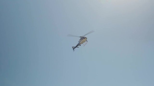 helicopter on a background of blue sky and the sun with highlight
