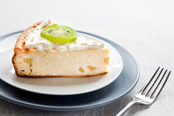 Homemade cottage cheese cake with kiwi fruit and cream