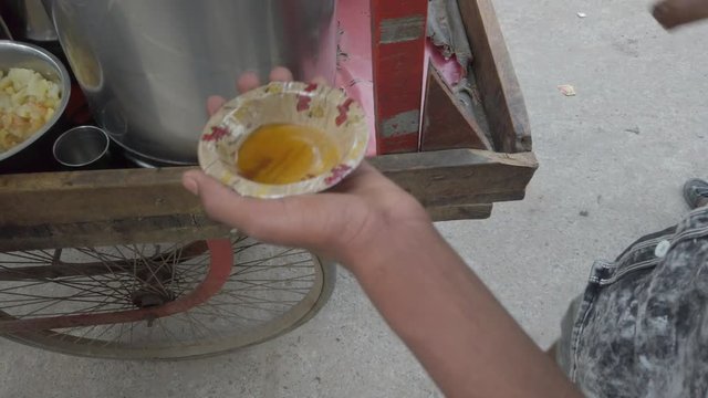 Slow motion prep of Panipuri or Golgappa, consists of a round, hollow puri, fried crisp filled with mix of flavored water, tamarind chutney, chili, chaat masala, potato, atta, chickpea. stabilized 4k
