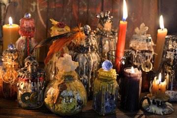 Witch laboratory with alchemy magic bottles in candlelight