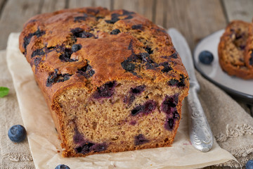 Banana bread on old wooden rustic table, slice of cake with banana, side view
