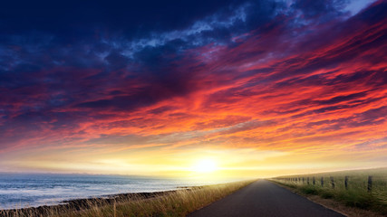 Fototapeta na wymiar Asphalt Road Sea Sunset .Sunset or sunrise with clouds . Paradise heaven . light about the sky .
