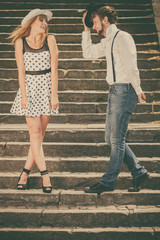 Loving couple retro style flirting on stairs