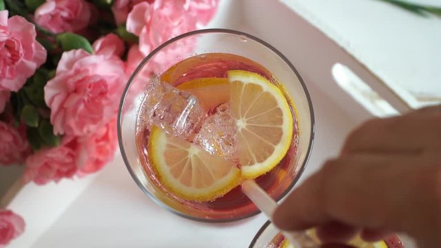 Top view on pink strawberry lemonade in glasses with tubule. Glasses with carbonated cocktail drink with lemon and ice with bubbles