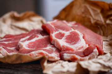 Fresh sliced meat on craft paper background. Cooking process. 