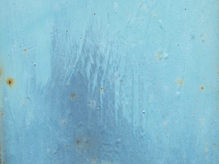 background image of blue paint smudges and rust on metal