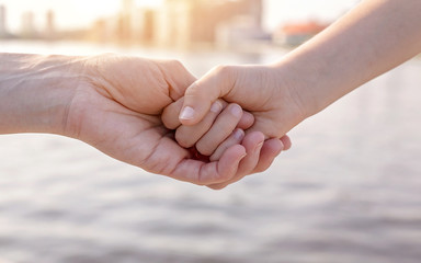 Happy family concept. Mom holds her daughter's hand.
