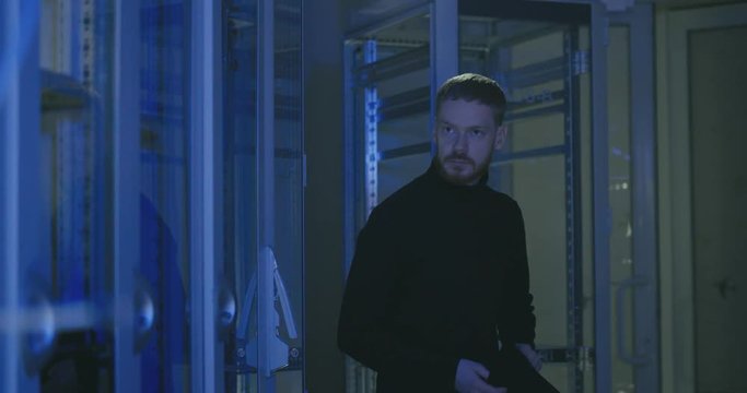 Anonymous caucasian young male hacker attacks data center