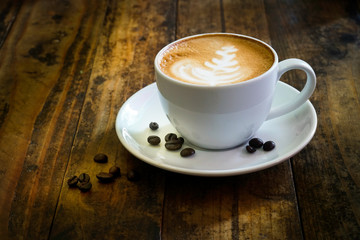 Coffee cup on wooden table at coffee shop. Business time with coffee, Coffee color brown background for product display, free copy space. Industrial food, drink background concept.