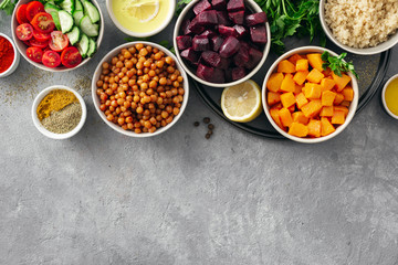 Set of healthy vegetarian ingredients for cooking. Spiced chickpeas, Baked pumpkin and beets, quinoa and vegetables on concrete background with copy space top view