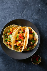 Tortilla aloo gobi chickpeas dark background top view