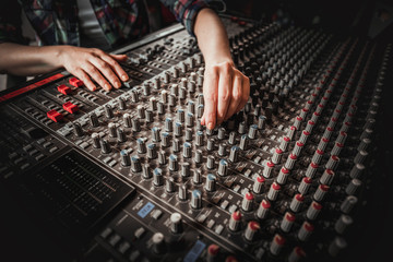 Sound recording studio mixing desk, sound engineer or music producer working at new song