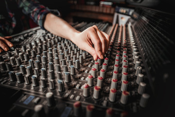 Sound recording studio mixing desk, sound engineer or music producer working at new song
