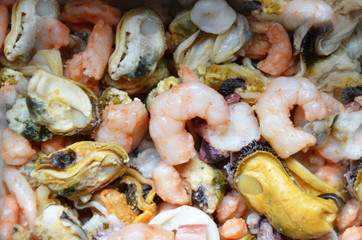 Shellfish plate of crustacean seafood mussels, oysters as an ocean gourmet dinner background. Various seafood ready to eat. Shrimps, octopus, squid, oysters. Background without focus