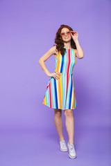 Full length portrait of a pretty young redheaded woman