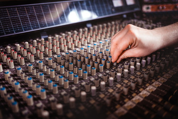 Recording studio mixing desk, music producer using soundboard