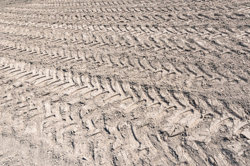 Tire tracks on the dry field at day time.