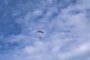 paraglider in the sky,flying, extreme, air, adventure, freedom, gliding, clouds, sports, glider, paraglide, wind, flight, activity, fun, high, cloud, people 