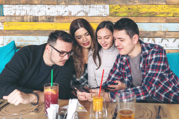 Best friends having fun at restaurant sharing photos on social media