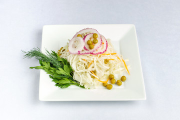 Salad of sauerkraut with onions and green peas.