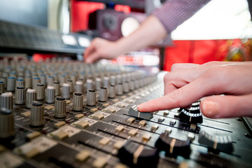 Fototapeta na wymiar Music engineers working together in recording studio using mixing desk