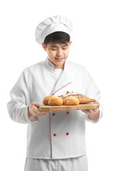 Asian chef with fresh bakery products on white background