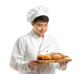 Asian chef with fresh bakery products on white background