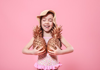 cheerful summer girl with pineapple on colored background