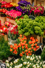Fototapeta na wymiar Beautiful orange tulips, peonies and ranunculus flower bouquet and others. Spotted on the flower market.