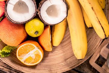 Fresh different organic fruits on wooden plate close up Antioxidants, detox diet, organic fruits