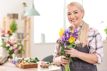 Female florist with beautiful bouquet in shop