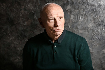 Portrait of senior man on grunge background