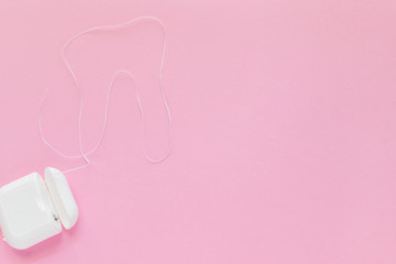 Dental hygiene - tooth brushes, dental floss, mouthwash flat lay, top view, copy space, pink background
