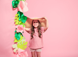 Little cute girl in summer hat on color background