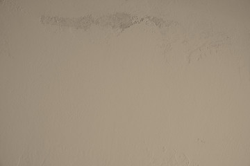 Pastell Braun, Betonwand mit schmutziger, alter, rauer Struktur im oberen Teil des Bildes. Steinwand, Zementwand im Industrial Style als Hintergrund, Tapete, Gestaltungselement, Kunst