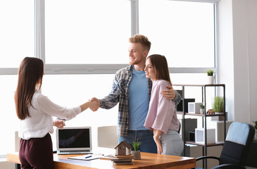 Young couple in office of real estate agent