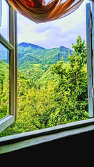 Open window with a view of the mountain peaks