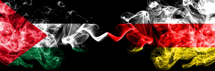Palestine vs South Ossetia smoky mystic flags placed side by side. Thick colored silky smokes flag of Palestinians and South Ossetia