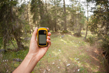 a trekker using a gps inside the forest