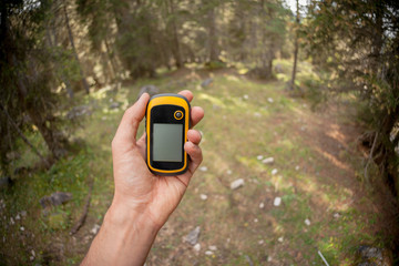 a trekker using a gps inside the forest