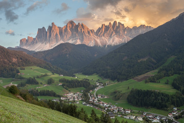 Fototapeta premium Small Italian mountain town of St. Magdalena in Val di Funes at sunset