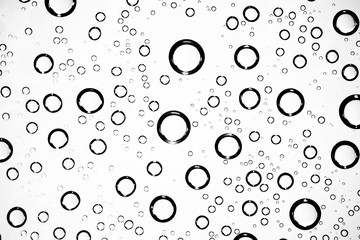 white isolated background water drops on the glass / wet window glass with splashes and drops of water and lime, texture autumn background