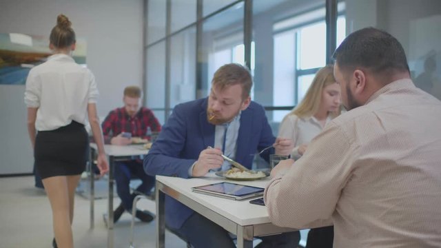Businessman during lunch staring at his colleague's legs