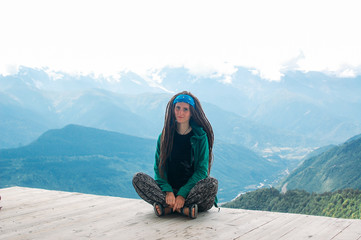 Naklejka na ściany i meble Hiking woman sitting with view on mountain in Svaneti in Georgia. Travel woman, wanderlust concept.