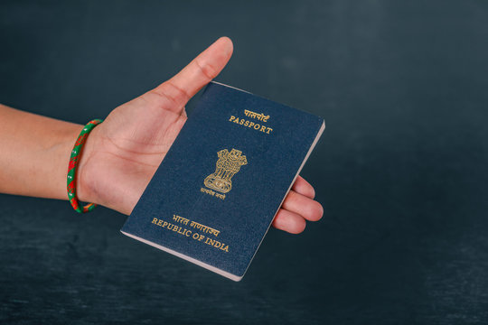 indian passport  in hand , showing passport