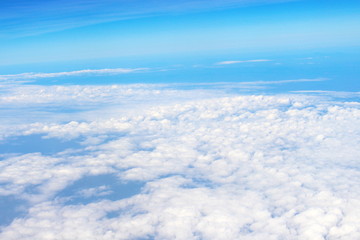 Fototapeta na wymiar Beautiful of blue sky and white cloud looks from the window of the plane
